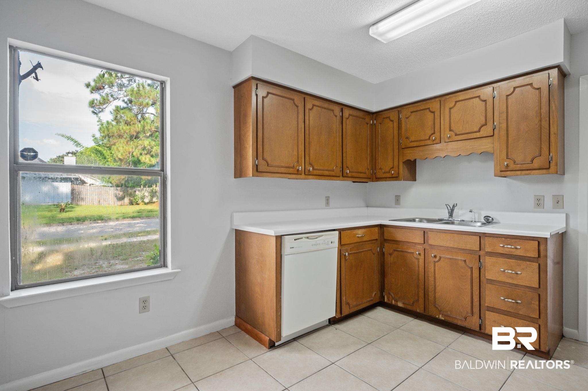 3701 Vista Ridge Drive Mobile, AL 36693 - Photo 12 of 33 Kitchen featuring light tile patterned flooring, sink, and white dishwasher