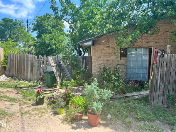a backyard of a house with table and chairs