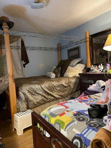 a bedroom with two bed and a lamp