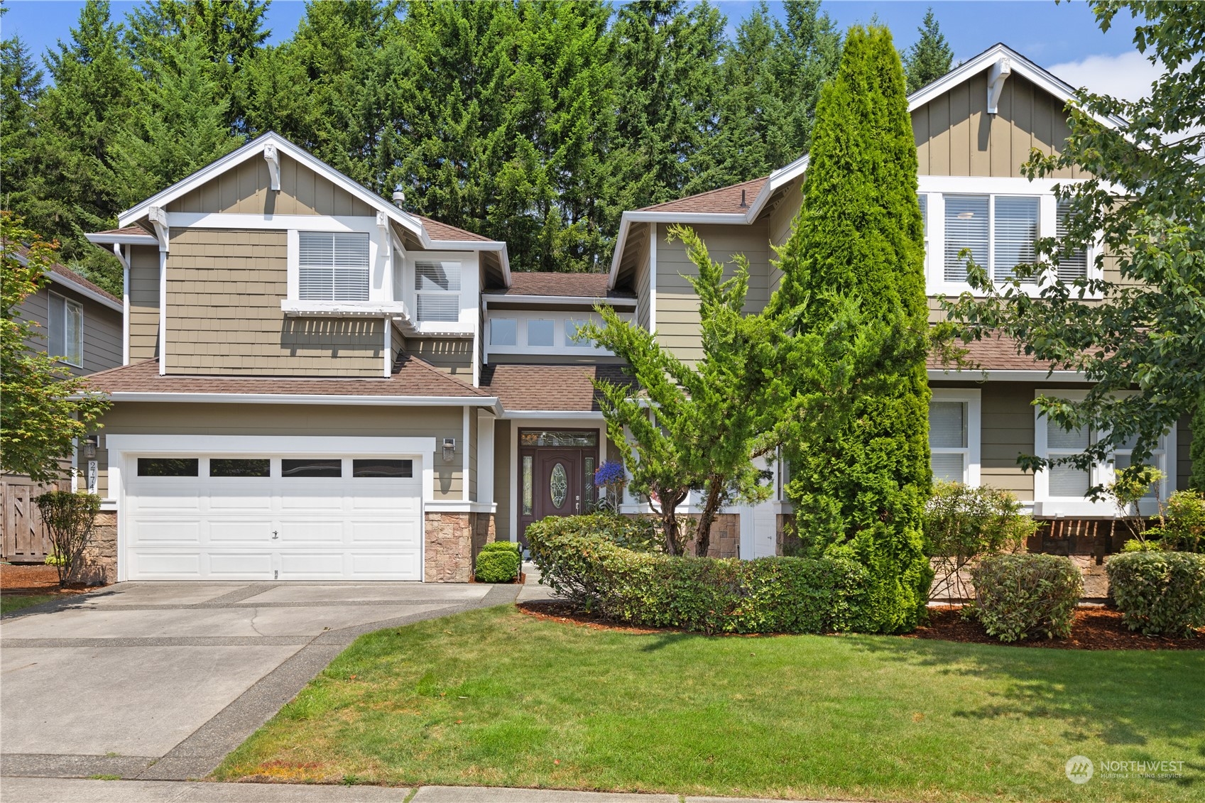 a front view of a house with a yard and garage