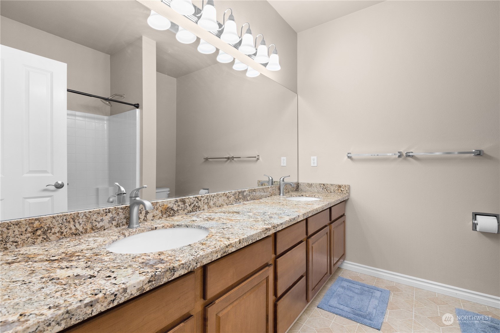 27746 Maple Ridge Way Southeast Maple Valley, WA 98038 - Photo 26 of 37 a bathroom with a granite countertop sink and a mirror