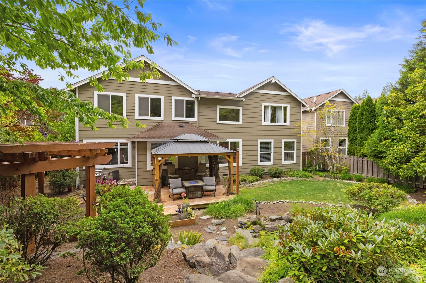 27746 Maple Ridge Way Southeast Maple Valley, WA 98038 - Photo 27 of 37 a front view of a house with garden