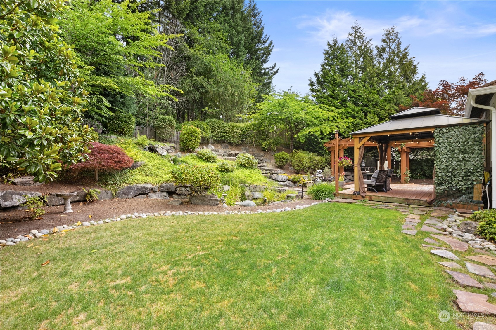 27746 Maple Ridge Way Southeast Maple Valley, WA 98038 - Photo 30 of 37 a view of a house with backyard porch and sitting area