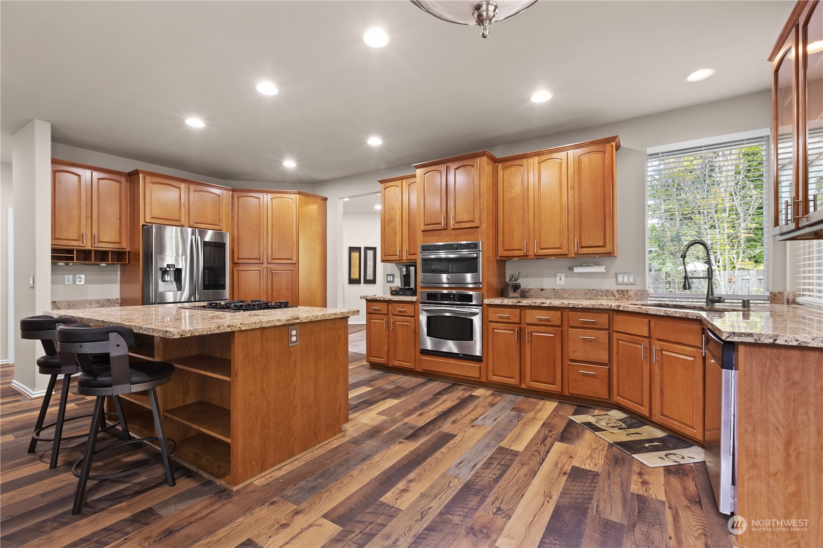 27746 Maple Ridge Way Southeast Maple Valley, WA 98038 - Photo 8 of 37 a kitchen with stainless steel appliances granite countertop sink stove top oven and cabinets