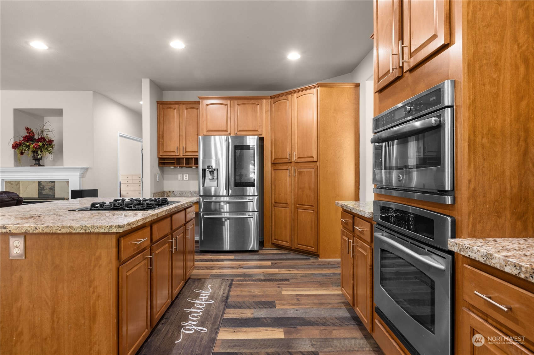 27746 Maple Ridge Way Southeast Maple Valley, WA 98038 - Photo 9 of 37 a kitchen with refrigerator a stove and cabinets