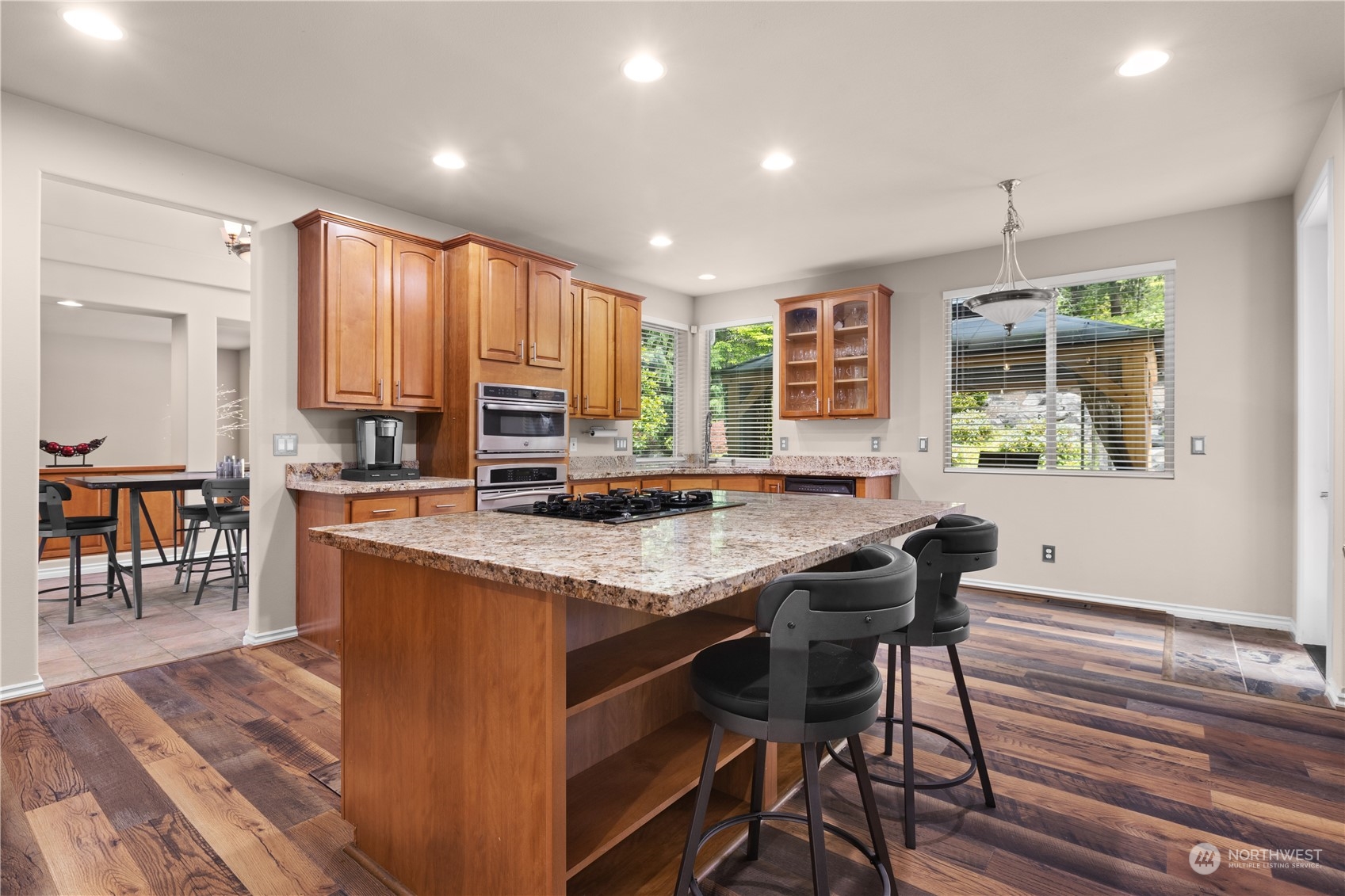 27746 Maple Ridge Way Southeast Maple Valley, WA 98038 - Photo 10 of 37 a kitchen with stainless steel appliances granite countertop wooden cabinets a table and chairs