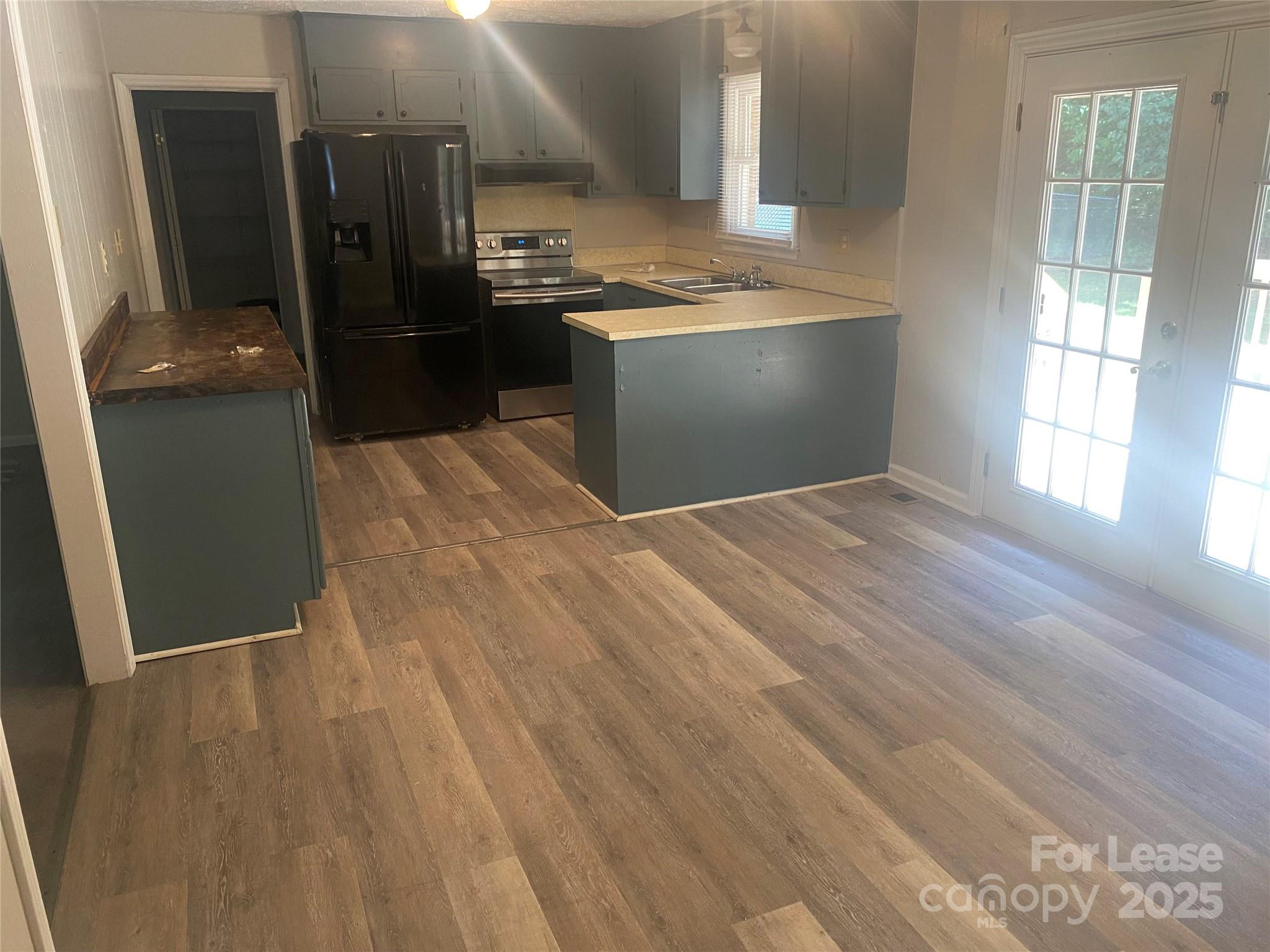 1427 Oak Hill Drive Morganton, NC 28655 - Photo 3 of 12 a view of a refrigerator in kitchen and wooden floor