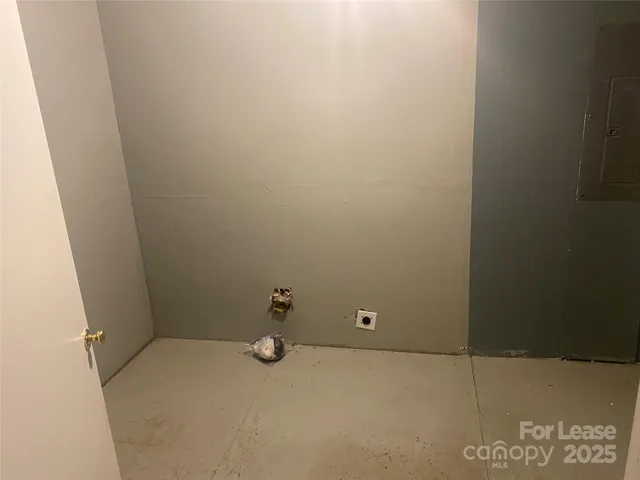 a view of a wooden deck and lake with trees in the background