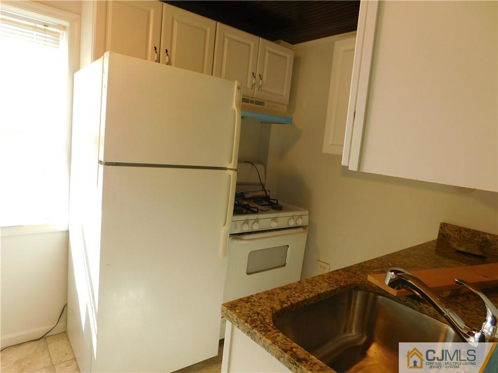 464 Harding Road Old Bridge, NJ 08879 - Photo 5 of 12 a white refrigerator freezer sitting inside of a kitchen