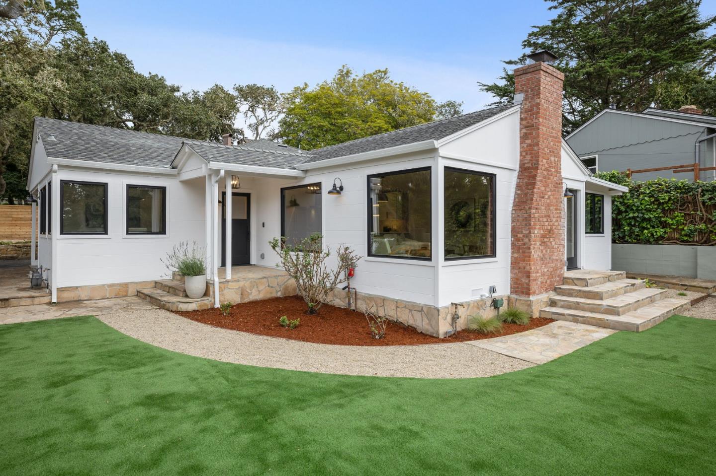 3130 Pico Avenue Carmel, CA 93923 - Photo 11 of 54 a front view of a house with a yard table and chairs
