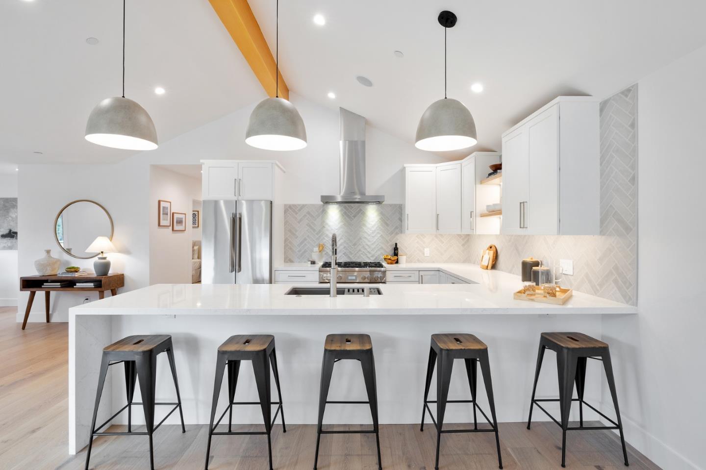 3130 Pico Avenue Carmel, CA 93923 - Photo 19 of 54 a kitchen with stainless steel appliances granite countertop a stove a sink and a dining table with chairs