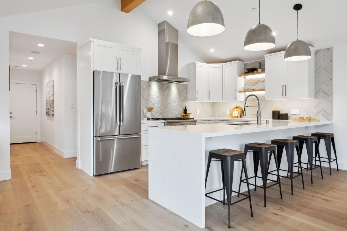 3130 Pico Avenue Carmel, CA 93923 - Photo 20 of 54 a kitchen with granite countertop a refrigerator a stove a sink and white cabinets with wooden floor