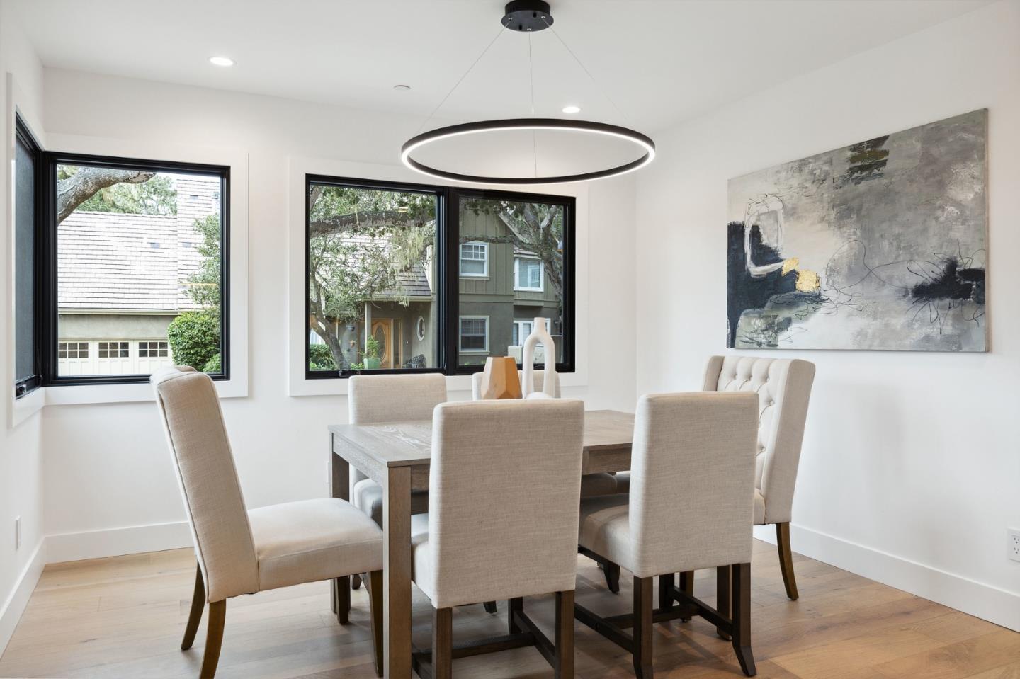 3130 Pico Avenue Carmel, CA 93923 - Photo 28 of 54 a dining room with furniture a chandelier and wooden floor