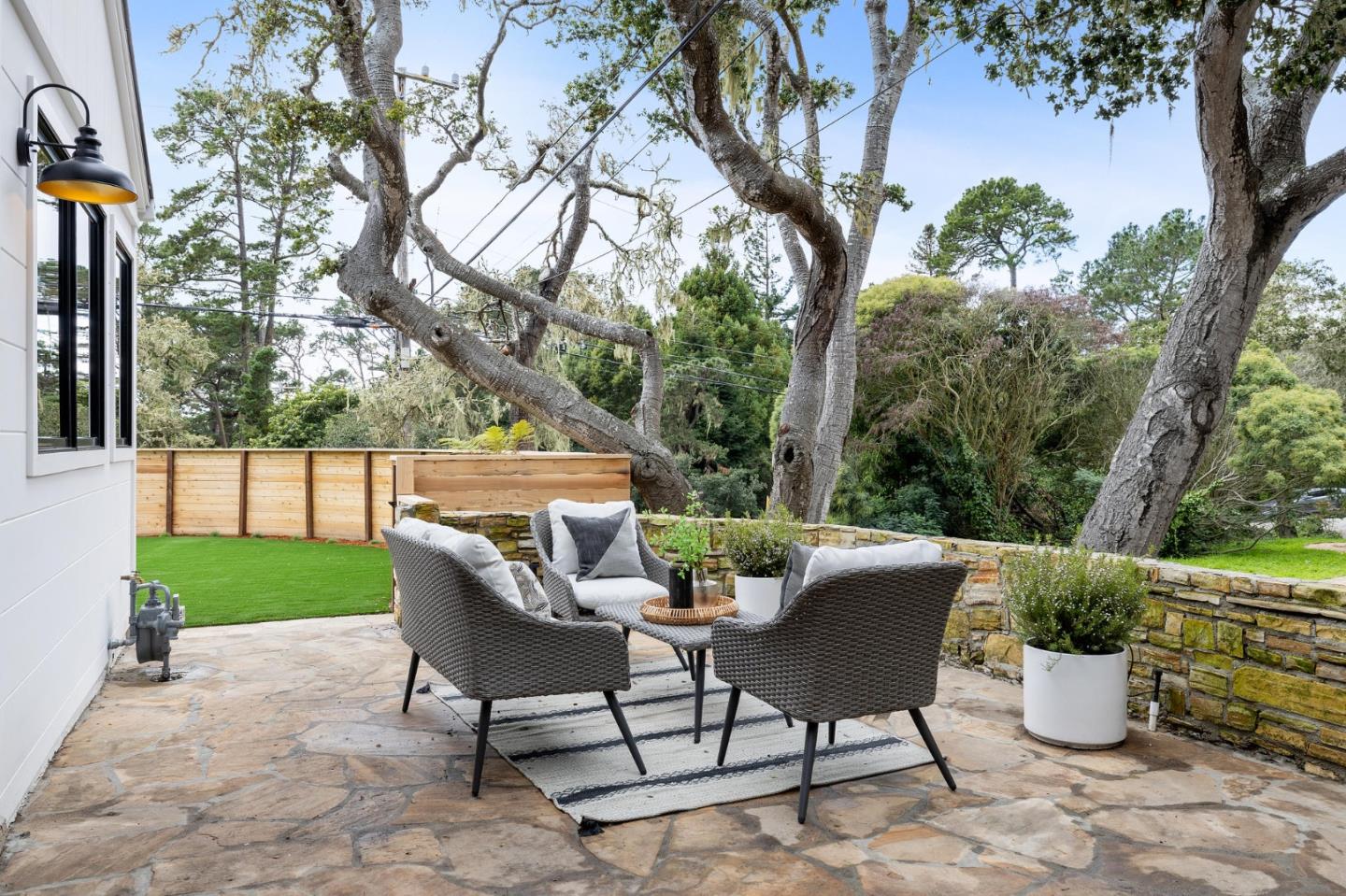 3130 Pico Avenue Carmel, CA 93923 - Photo 8 of 54 a view of a patio with table and chairs and a large tree