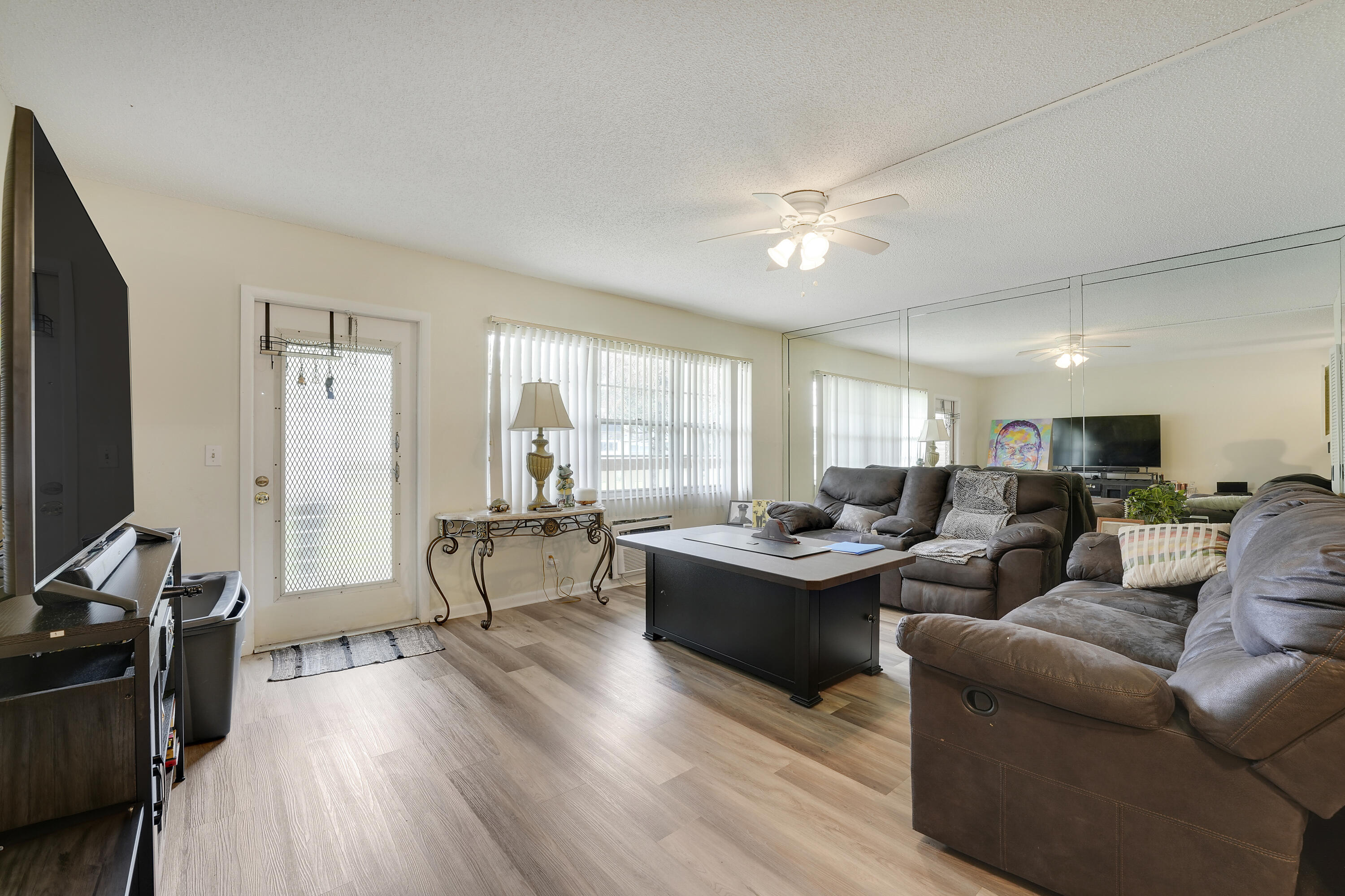 146 Mansfield D Boca Raton, FL 33434 - Photo 2 of 12 a living room with fireplace furniture and a flat screen tv