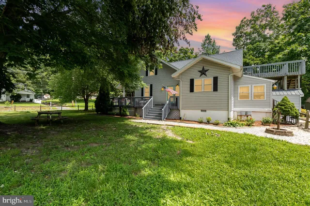 a front view of house with yard and trees