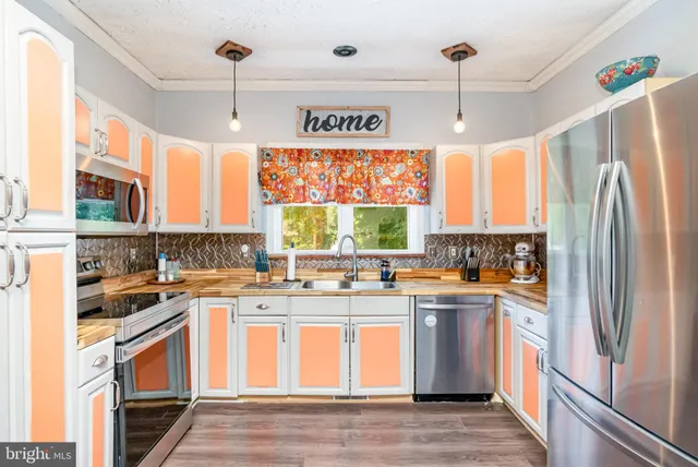 a kitchen with a stove a refrigerator and a sink