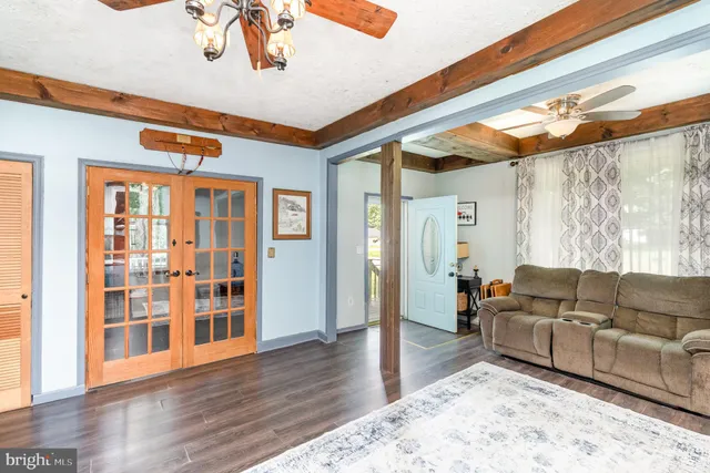 a living room with furniture and wooden floor