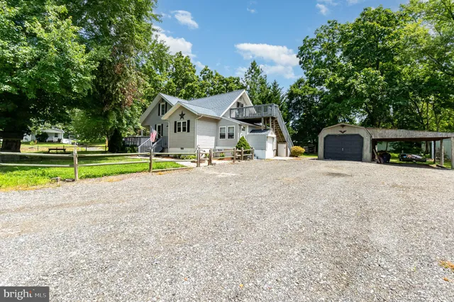 a view of a house with a swimming pool and a yard