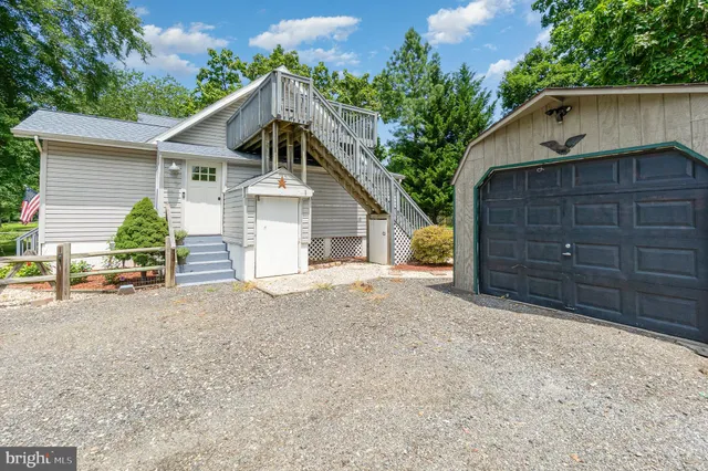 a view of a house with a yard and garage