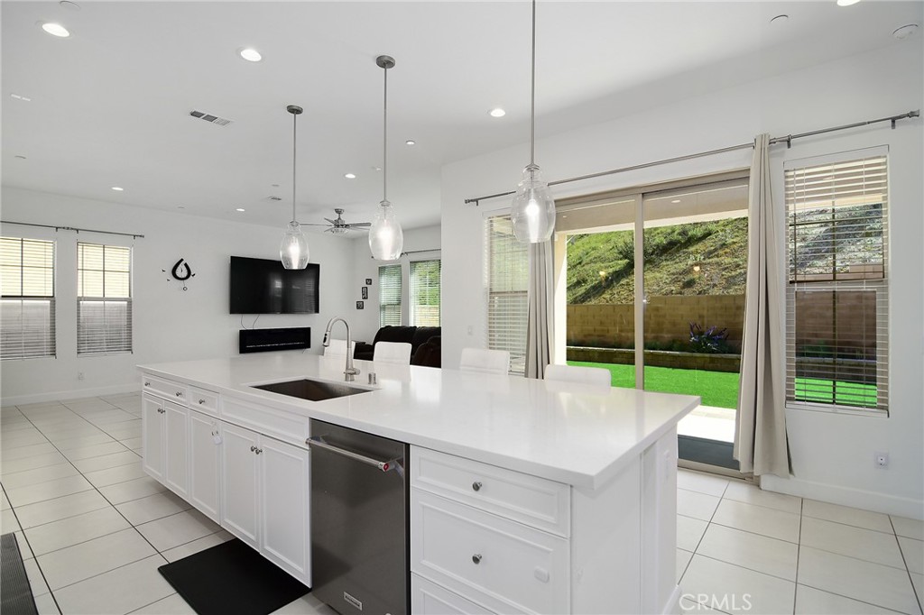 24336 Sterling Ranch Road West Hills, CA 91304 - Photo 16 of 40 a large white kitchen with a large window