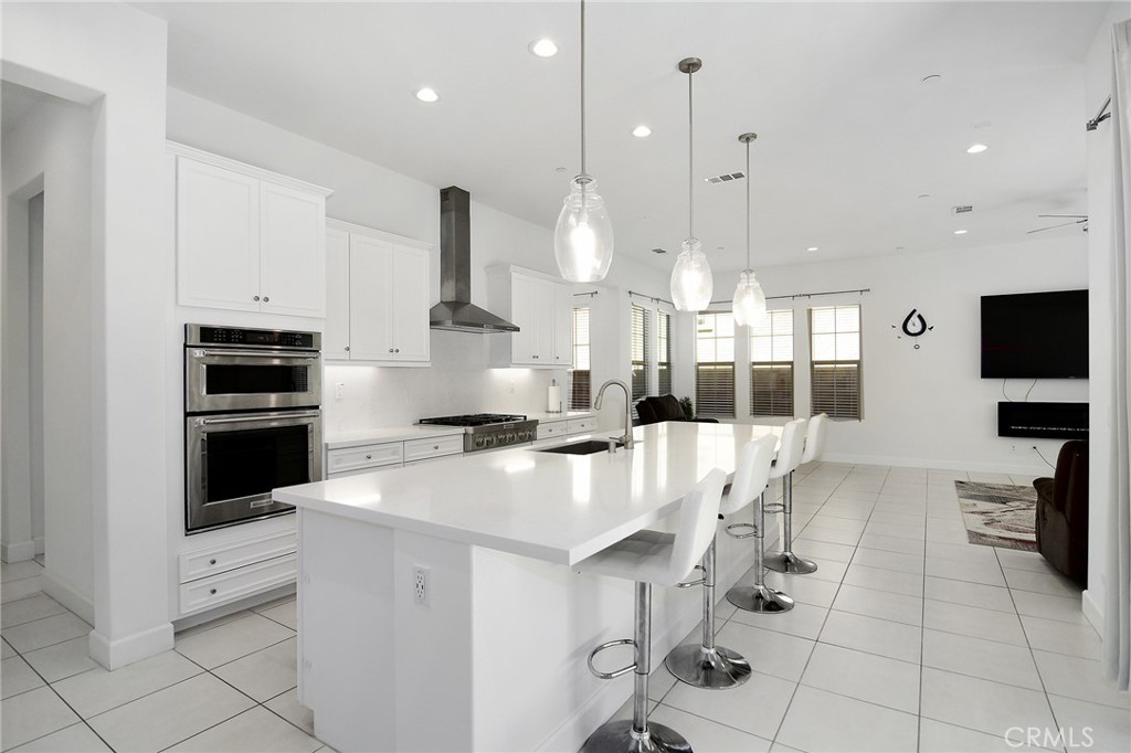 24336 Sterling Ranch Road West Hills, CA 91304 - Photo 17 of 40 a kitchen with white cabinets and stainless steel appliances