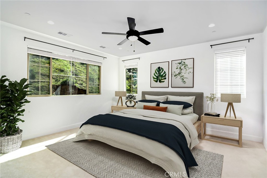 24336 Sterling Ranch Road West Hills, CA 91304 - Photo 19 of 40 a bedroom with a large bed and a chandelier