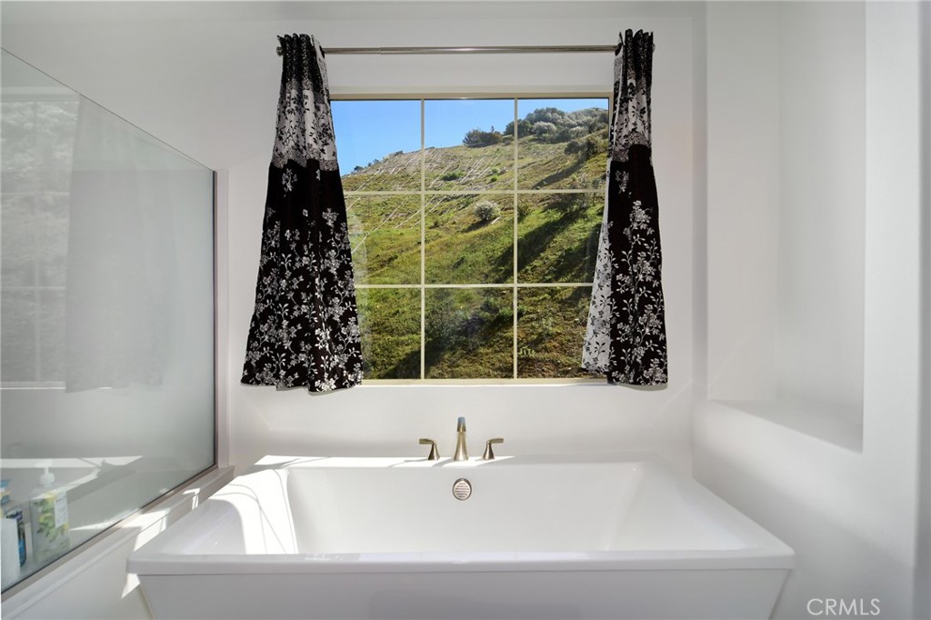 24336 Sterling Ranch Road West Hills, CA 91304 - Photo 24 of 40 a bathroom with a bathtub and shower