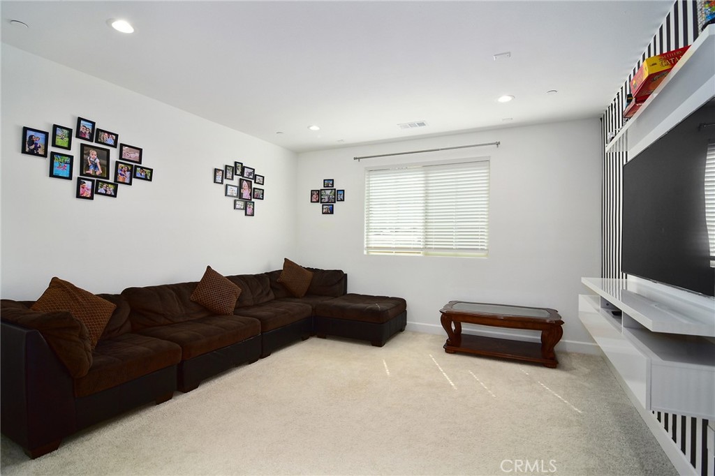 24336 Sterling Ranch Road West Hills, CA 91304 - Photo 29 of 40 a living room with furniture and a flat screen tv