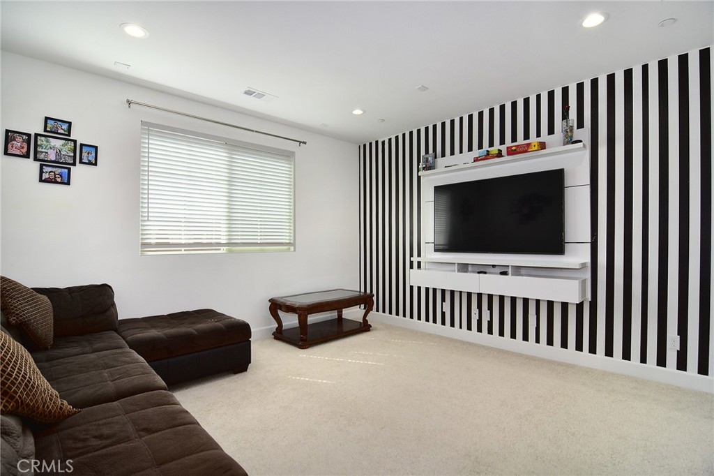 24336 Sterling Ranch Road West Hills, CA 91304 - Photo 30 of 40 a living room with furniture fireplace and flat screen tv