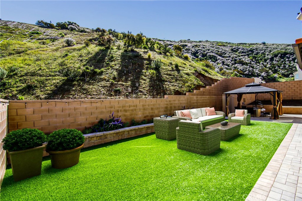 24336 Sterling Ranch Road West Hills, CA 91304 - Photo 32 of 40 a view of a house with backyard sitting area and garden