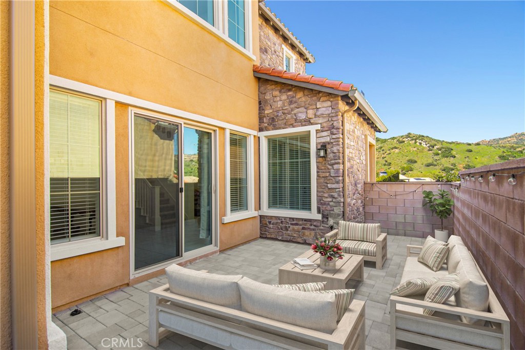 24336 Sterling Ranch Road West Hills, CA 91304 - Photo 33 of 40 a balcony with furniture and large windows