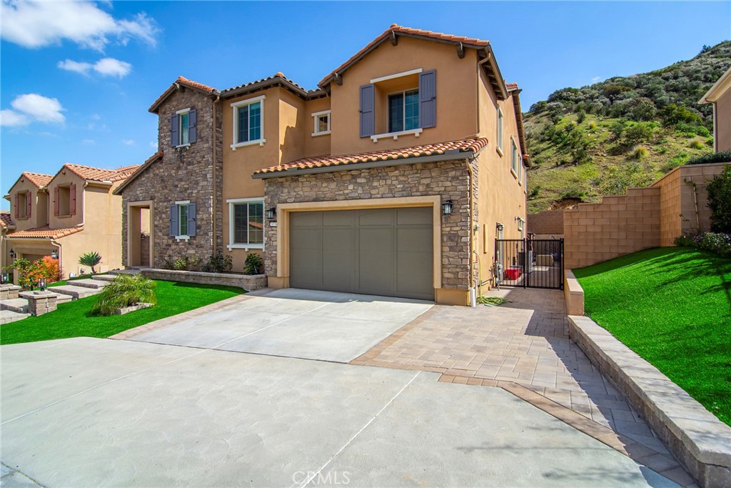 24336 Sterling Ranch Road West Hills, CA 91304 - Photo 6 of 40 a front view of a house with a garden and yard