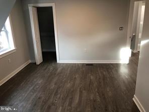 538 Newcomb Street Southeast Washington, DC 20032 - Photo 29 of 29 an empty room with wooden floor and windows