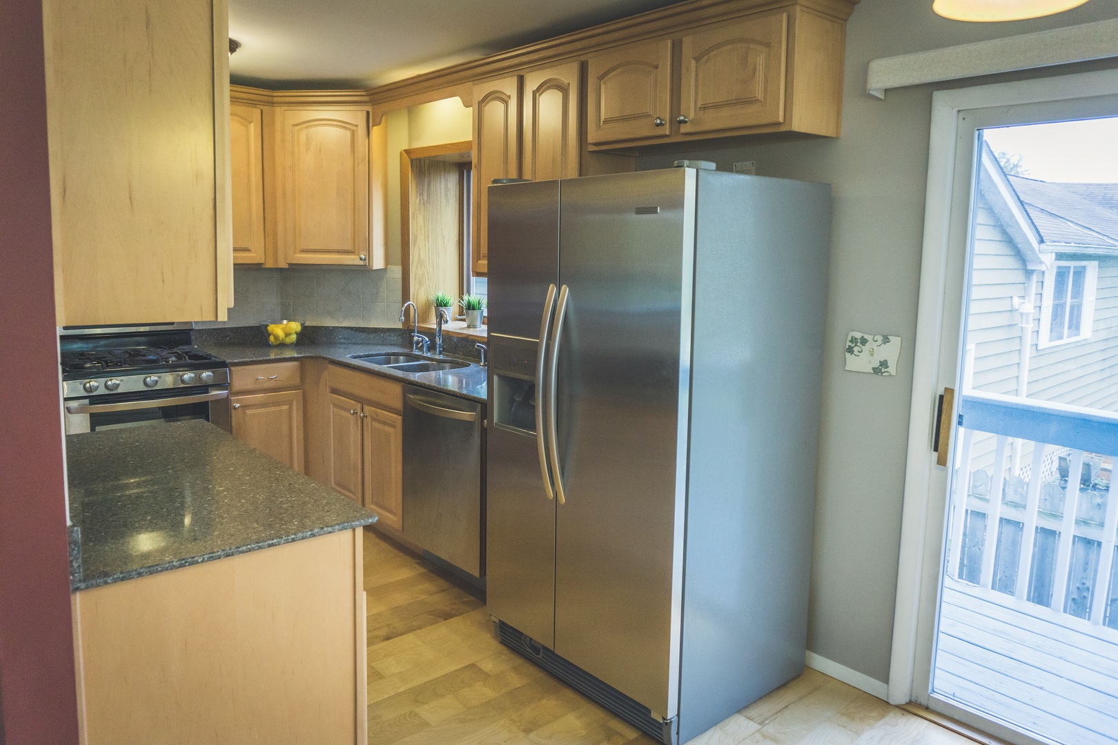 28939 May Street Spring Grove, IL 60081 - Photo 7 of 28 a kitchen with granite countertop a refrigerator and a sink
