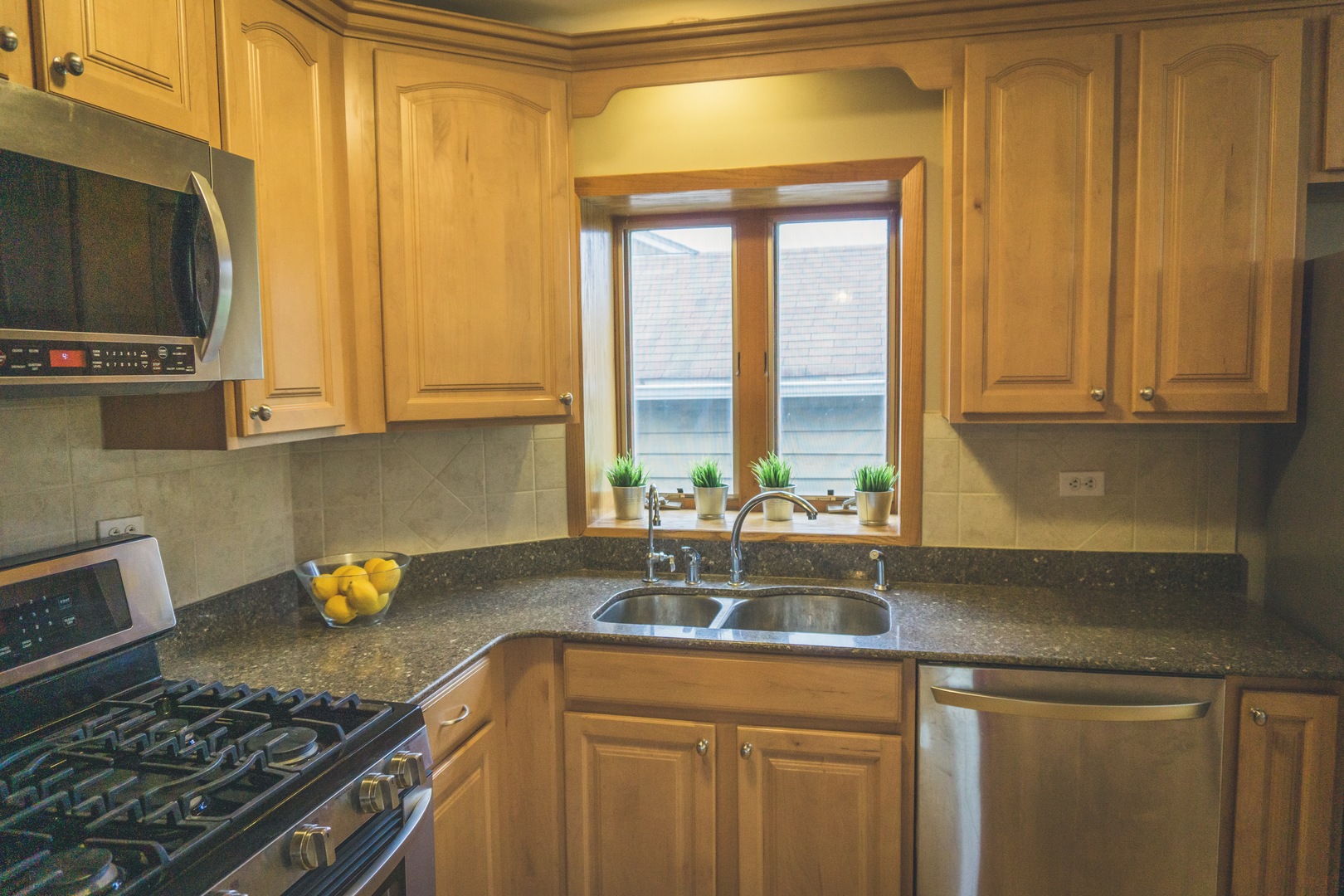 28939 May Street Spring Grove, IL 60081 - Photo 8 of 28 a kitchen with a stove a sink and a microwave