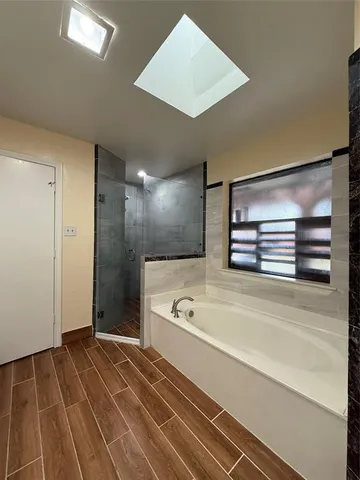 a bathroom with a bathtub and a shower