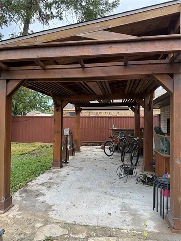 a view of a patio with table and chairs under an umbrella