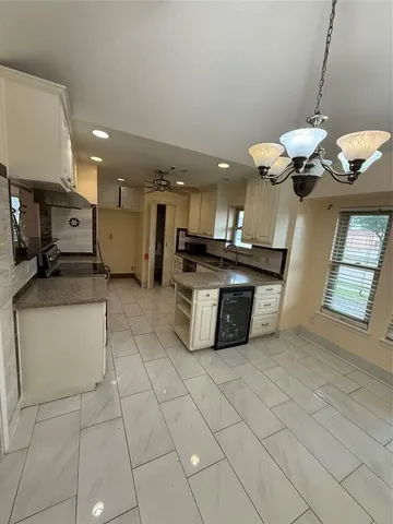 a kitchen with stainless steel appliances granite countertop a sink a stove and cabinets