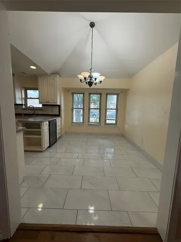 a view of a room with window and chandelier