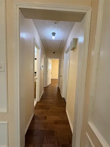a view of a hallway with a wooden door