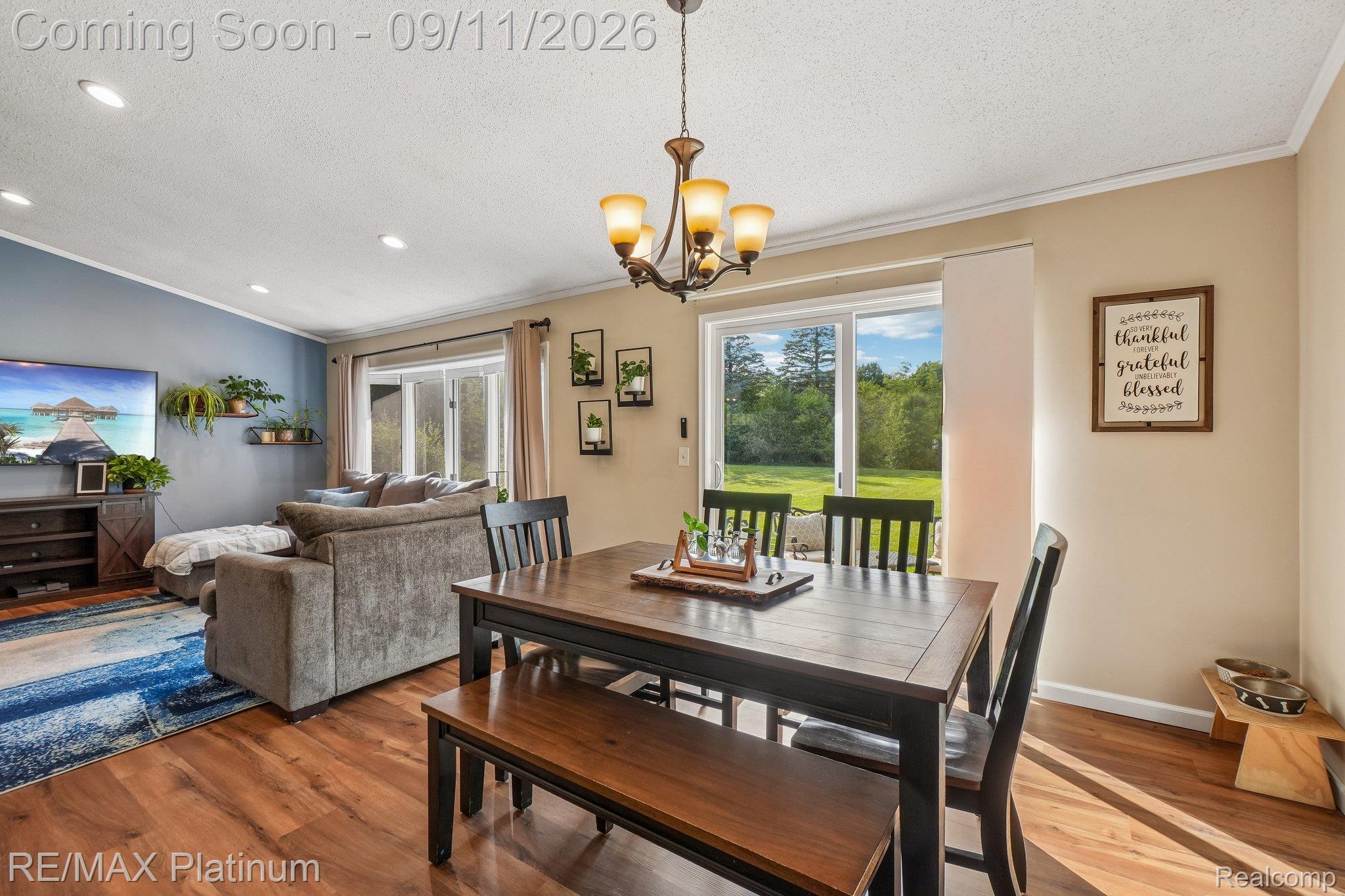 12126 Linden Road Linden, MI 48451 - Photo 7 of 38 LVP flooring, recessed lighting, and a multi-light chandelier