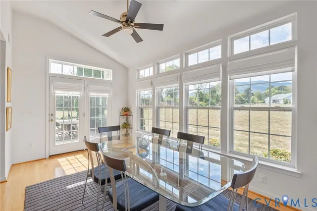 a living room with furniture and a large window with wooden floor