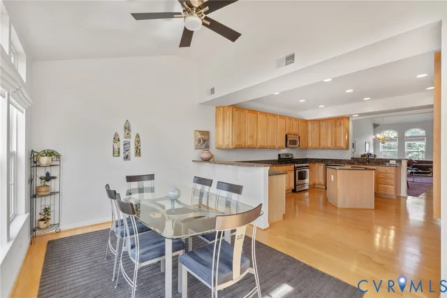 a dining room with kitchen island a table and chairs