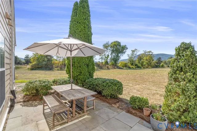 a backyard of a house with yard and outdoor seating
