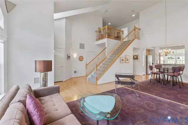 a living room with furniture and a dining table