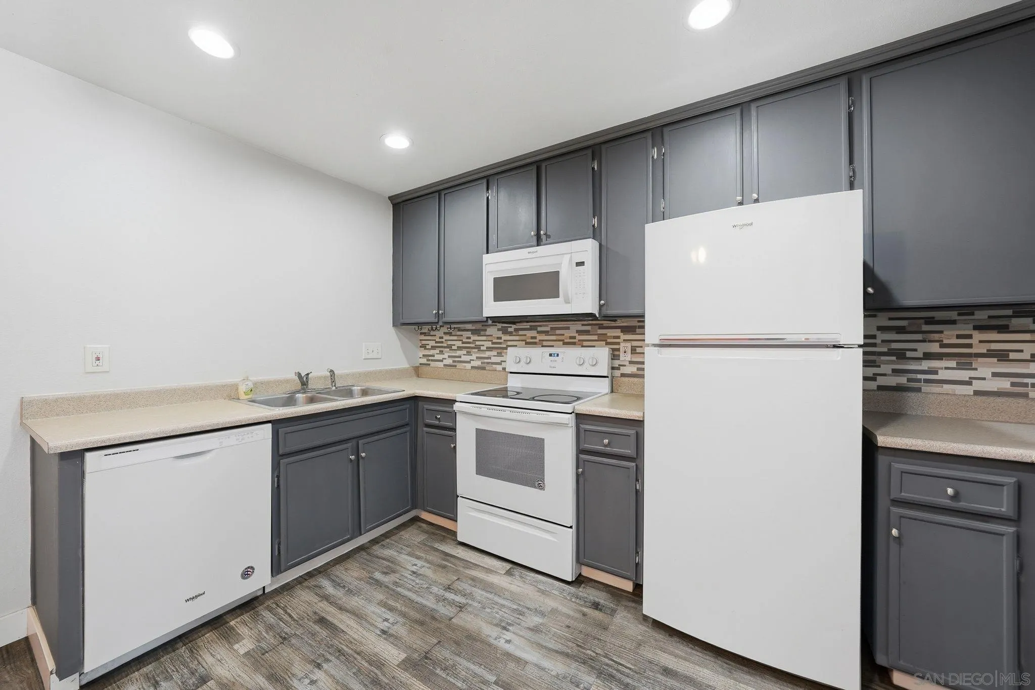 293 Sycamore Road, Unit 15 San Ysidro, CA 92173 - Photo 8 of 25 a kitchen with a refrigerator sink and stove