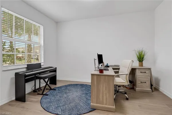 a view of a workspace with furniture and a window