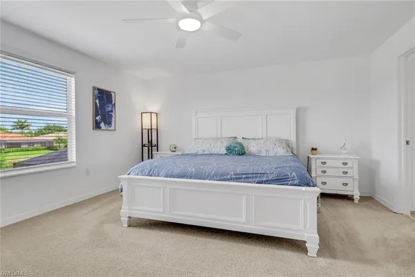 a bedroom with a bed and window