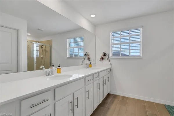 a bathroom with a sink a mirror and a window